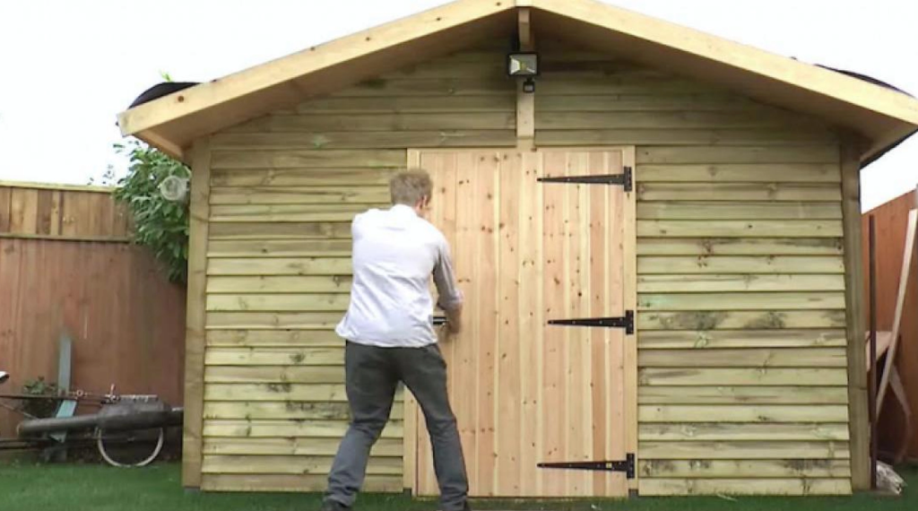 It looks like an ordinary garden shed, but wait until he opens the door