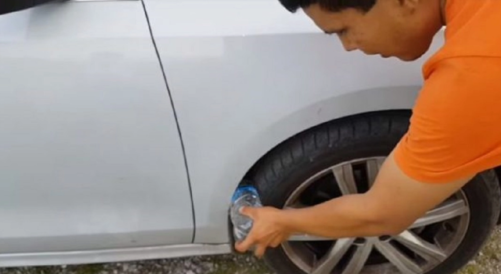 He places a plastic bottle next to the car’s tire—Many are left by surprise when they learn why