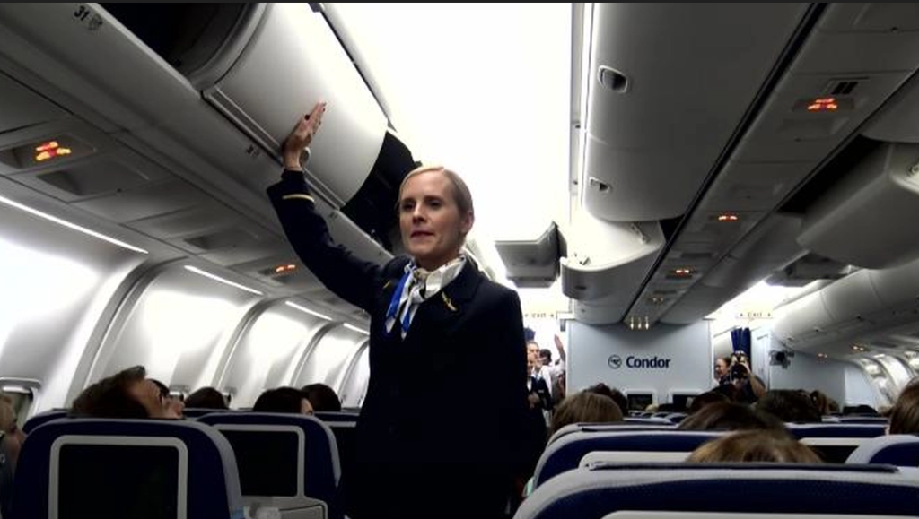 Stewardess knocks on overhead cabin, passengers get the surprise of their lives