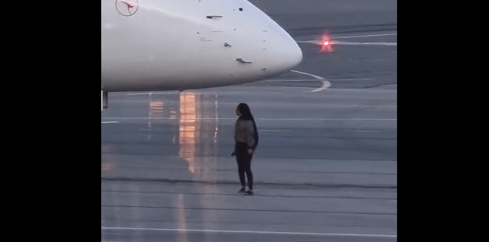 Video captures woman missing flight, breaching security, and running under plane